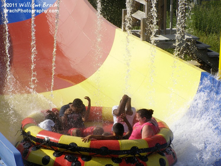 Riders getting drenched on the Penguin's Blizzard River near the splashdown.