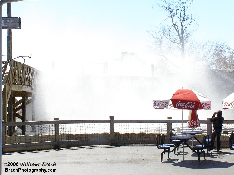 Huge blast of water soaking the riders and people on the bridge.