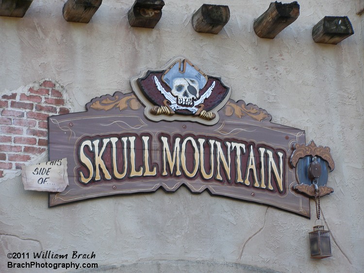 Sign for Skull Mountain on the side of the station building.