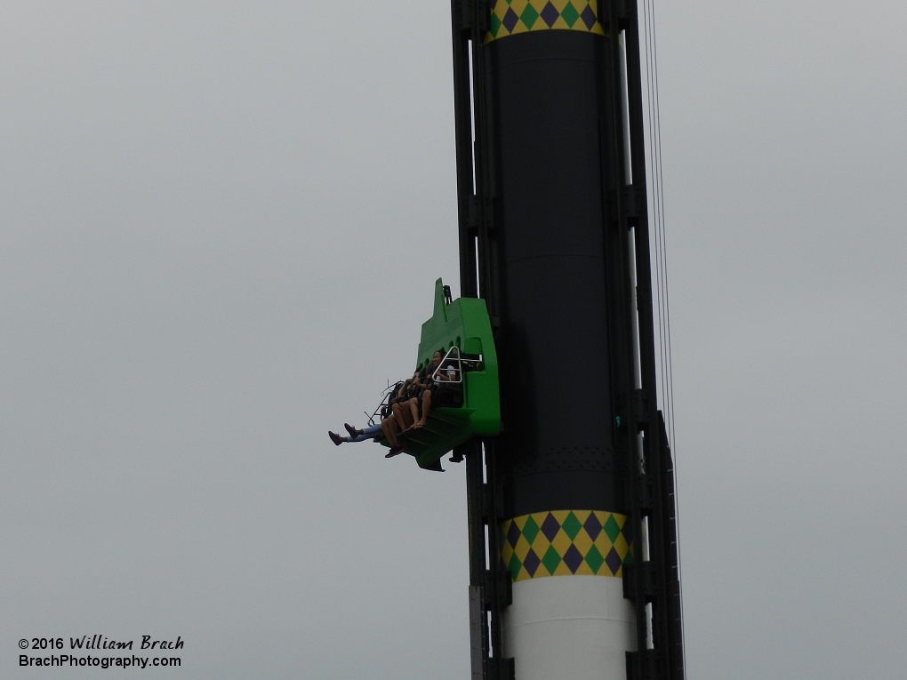 Riders free falling down the tower.  VooDoo Drop was previously known as the Tower of Doom until the 2014 season when the whole area was rethemed to Mardi Gras.