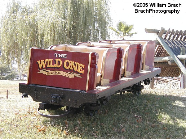 Older PTC bench train car used to mark the ride outside the queue entrance.