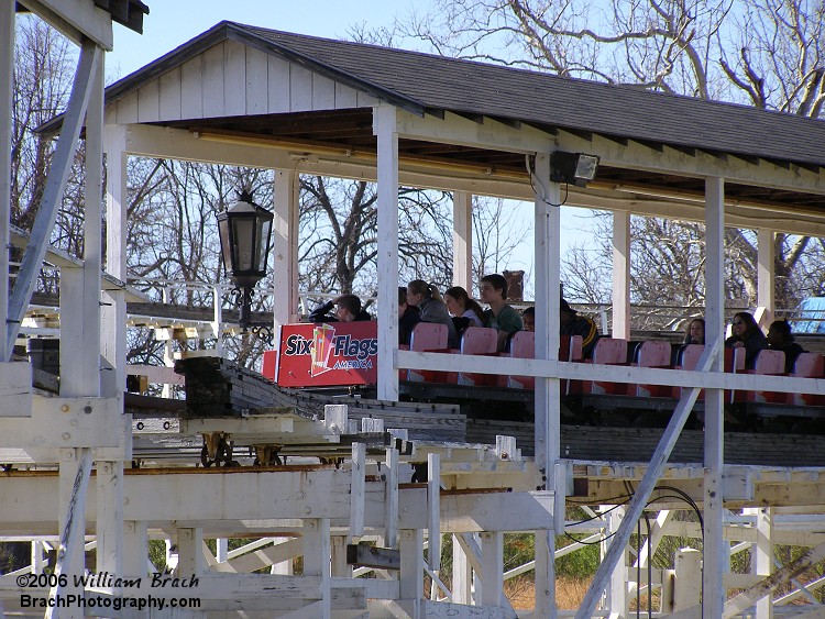 Wild One's red train awaits the blue train to depart the station while sitting in the brake run.