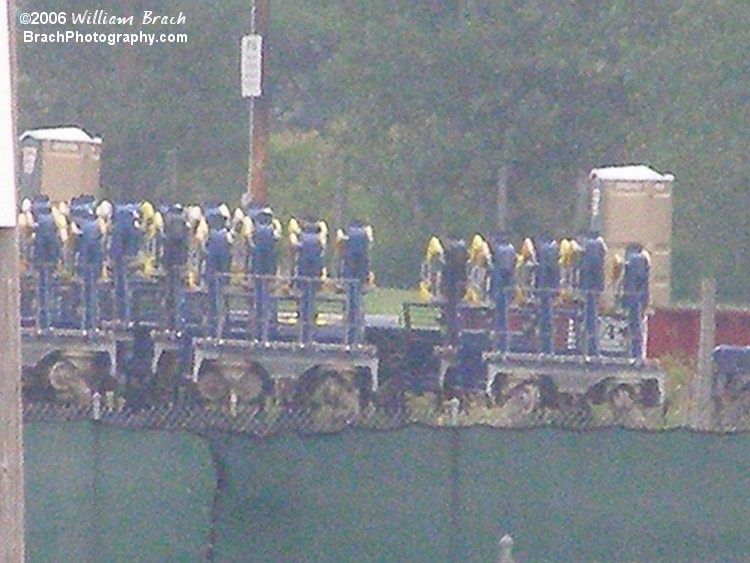 Digital zoom closer view of the trains from Batman: The Escape in storage.