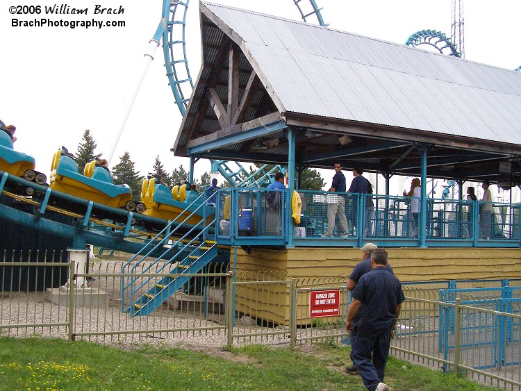 Boomerang: Coast to Coaster had malfunctioned and was actually stopped with the lead car's nose in the station.  Here we see two mechanics on the way to the station to figure out which light bulb burned out and if the park had any on hand or if they would need to order the builb.