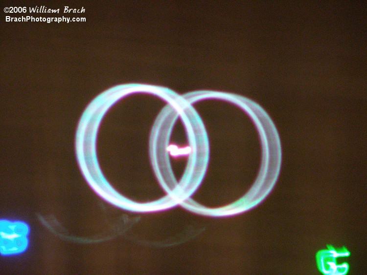 Closeup view of the white laser beams running on the screen.