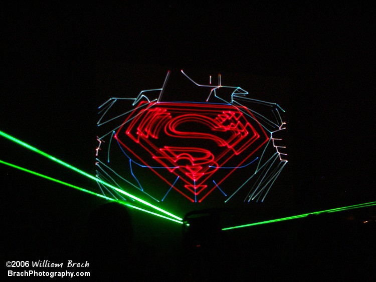 Superman revealing his "S" branding on his chest.