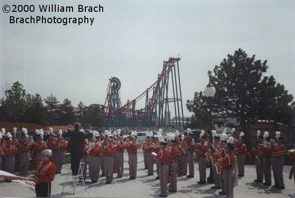 Mind Eraser running test runs in the background while a local high school band performs celebratory music on Opening Day 2000.