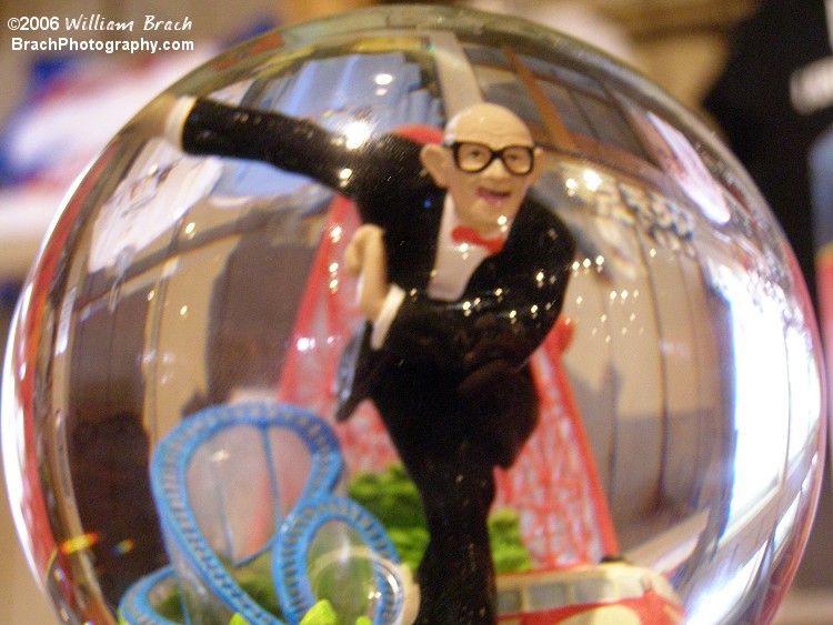 Mr. Six inside a snow globe specific to the park.