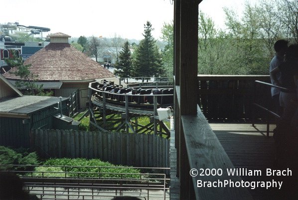 Black train leaving the station and heading towards the lift hill.