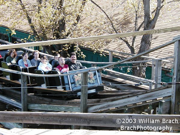 Predator's black train about to go up the lift hill on Opening Day 2003.