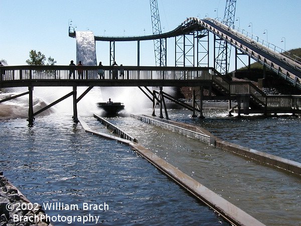 The huge wave is about to hit those people on the bridge.