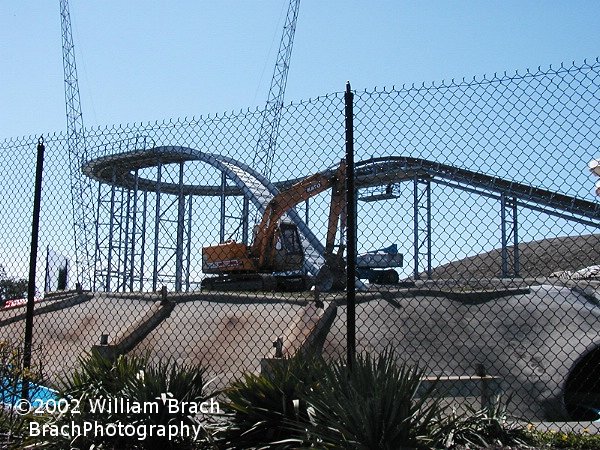 Here we see an Earth Mover that was still on site on Opening Day 2002.  Reminants of Cascade Canyon are still visible - those concrete footer supports for the slides.