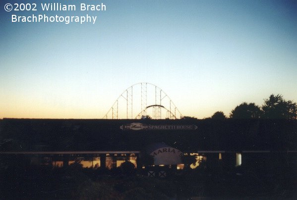 Train cresting the second hill at dusk.