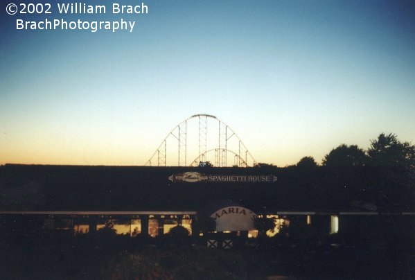 Train cresting the third hill at dusk.