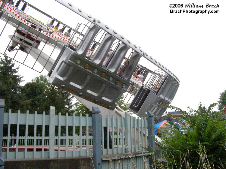 UFO is a cross between their Enterprise ride and Skylab rides.  There are no restraints on this ride since the centrifugal force is strong enough that it pushes the riders up against their backs hard enough, they don't have to worry about falling out.