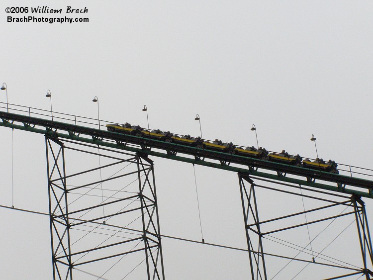 Yellow train going up the lift.