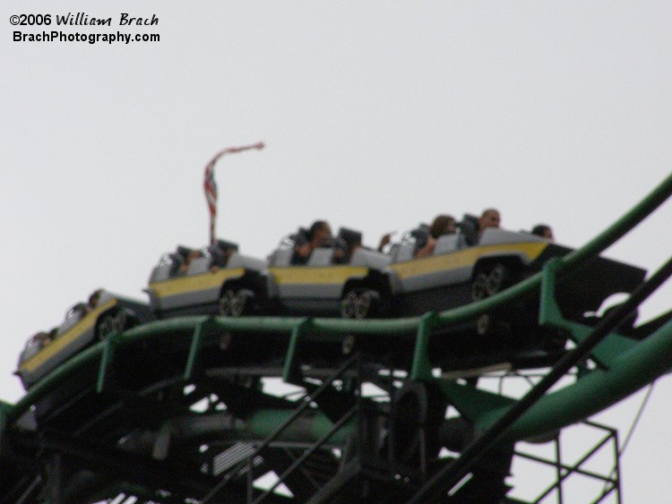 Yellow train cresting the top of the lift.