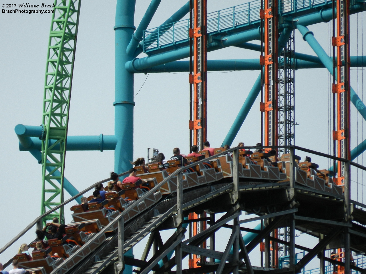 El Toro train going up the lift hill with Kingda Ka in the background.