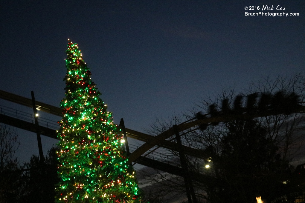 A Christmas tree with Batman in the background.