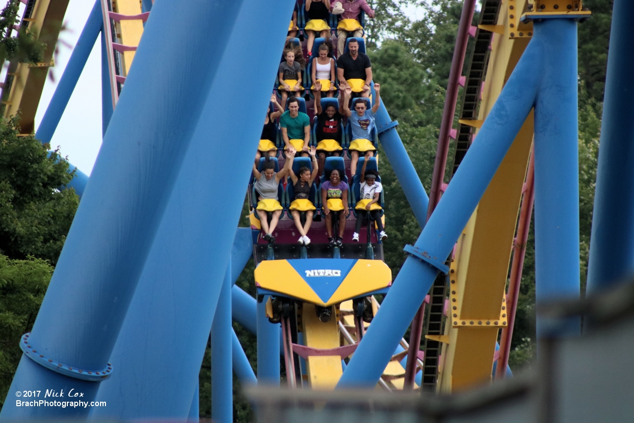 A train appears through the supports.