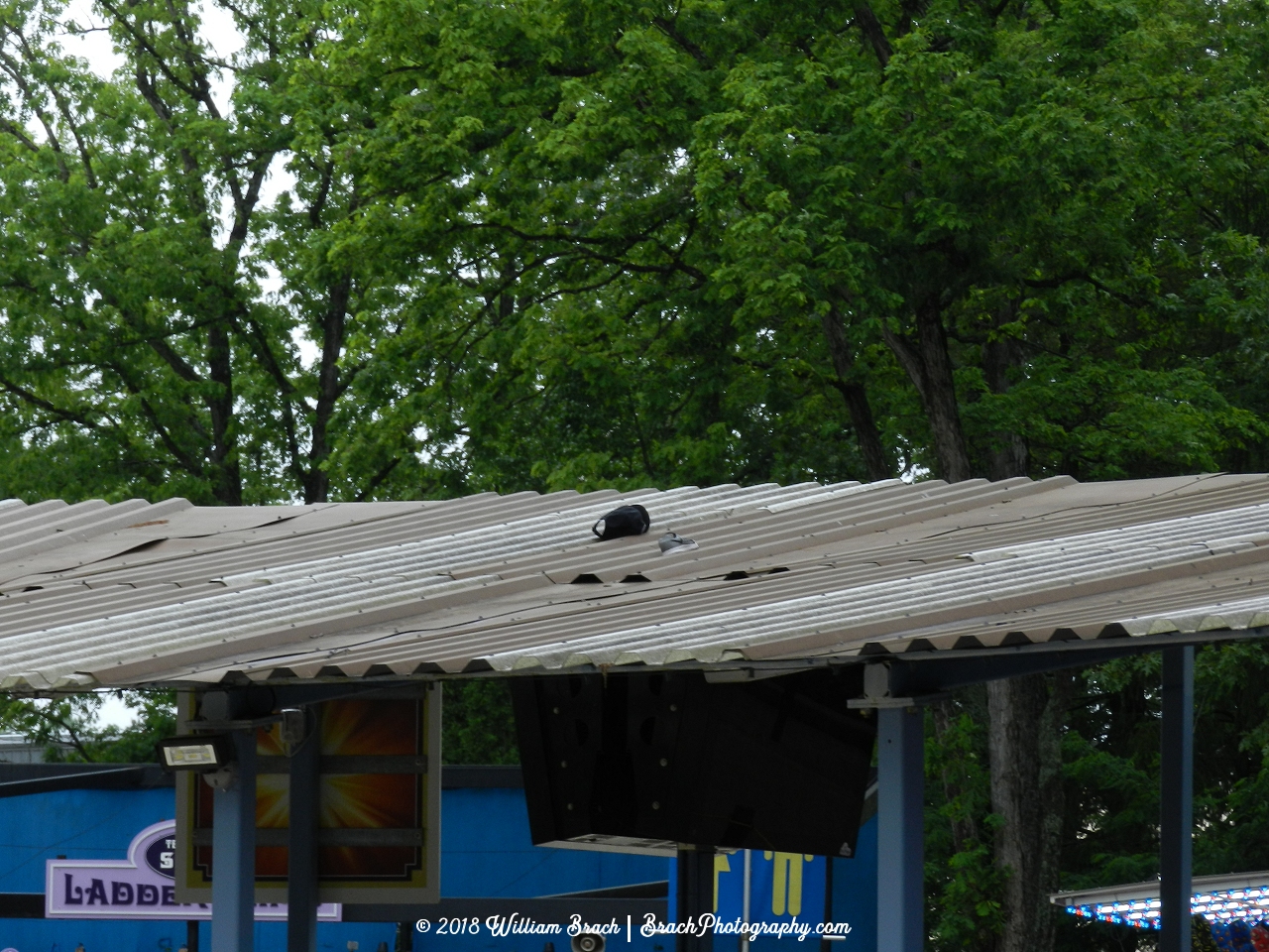 Sometimes a guest will violate the no loose articles policy on this ride and then their hats will end up on the queue roof.