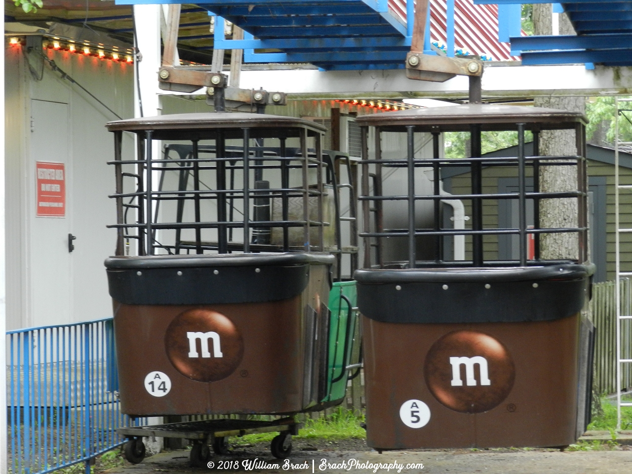 Here we see two brown and one green Skyway gondolas in storage waiting to be put onto the cable.