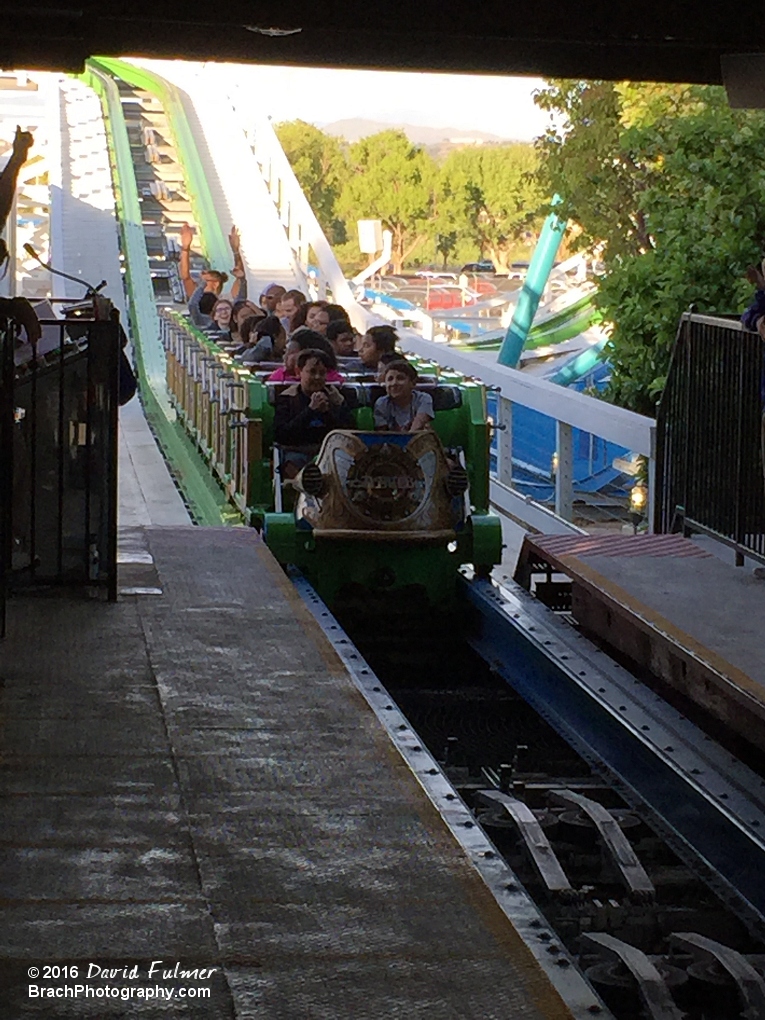 Green train returning to the station.