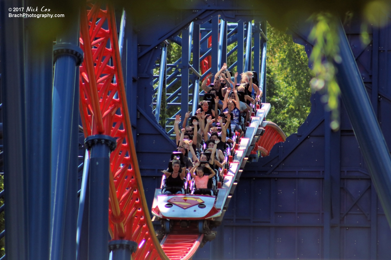 The train about to head over a giant hill.