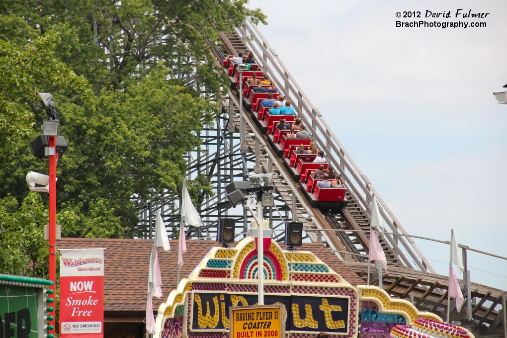 Seen distance of lift hill.  Notice the yellow sign in the foreground bottom - it says, "RAVINE FLYER II COASTER BUILT IN 2008."