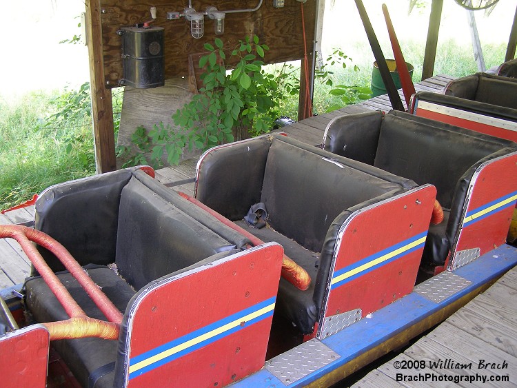 Amazing how much damage the sun can do to a parked train.  Loads of dust on the seats, the restraints are color-drained from the sun.