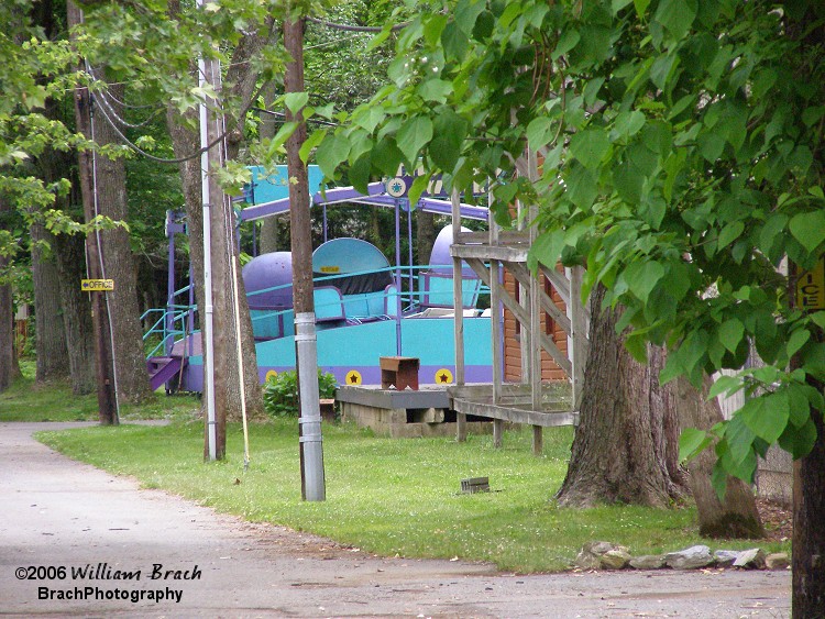 Williams Grove Park's Til-A-Whirl seen sitting idly from the front gate.