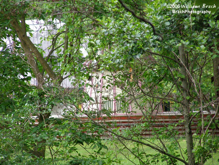 Very difficult to make out, but through the trees here, you can see the Wave Swinger that the park had.